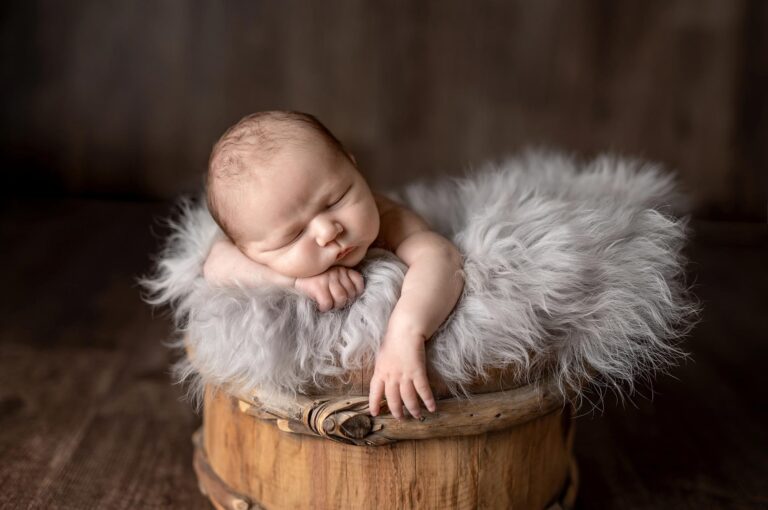 newborn baby in a bucket